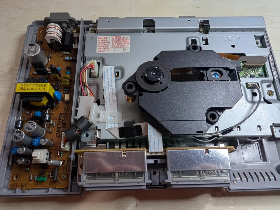 Lid off. Power supply on the left, disc drive on the right, and far less dust than the shell promised.