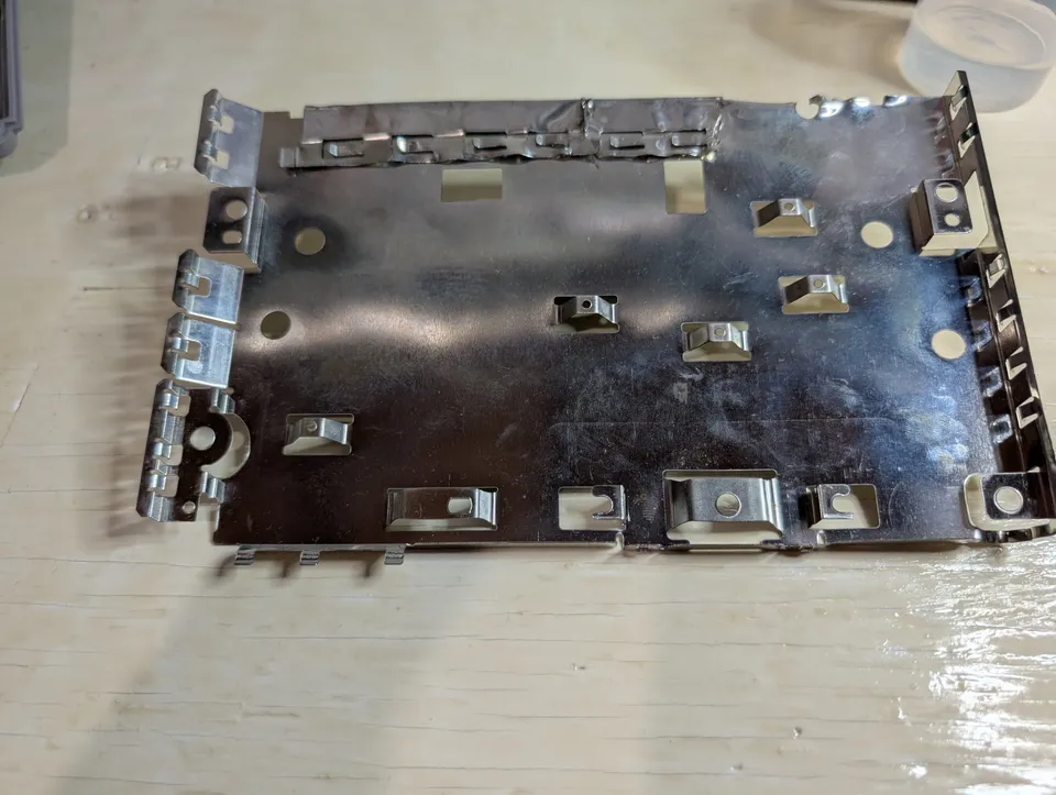 The shielding plate, cut and re-bent along the top edge by a previous owner.