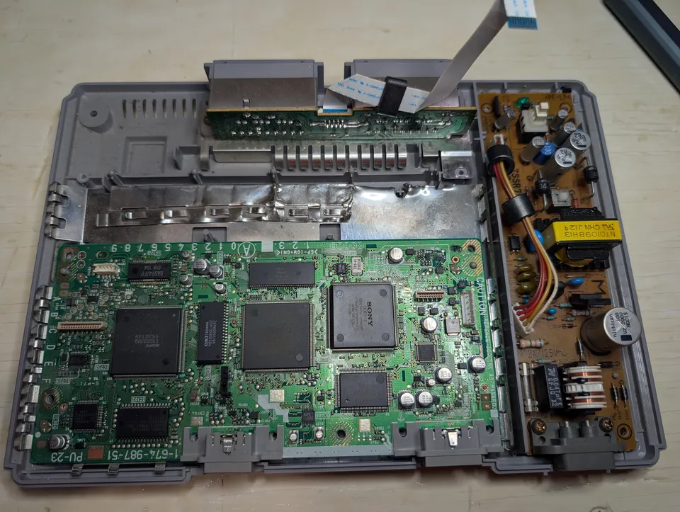 The board still in the shell, with the shielding plate on the power supply side.