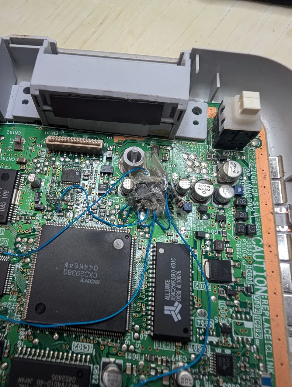 From above. The wires run loose over the big Sony chip and the RAM.